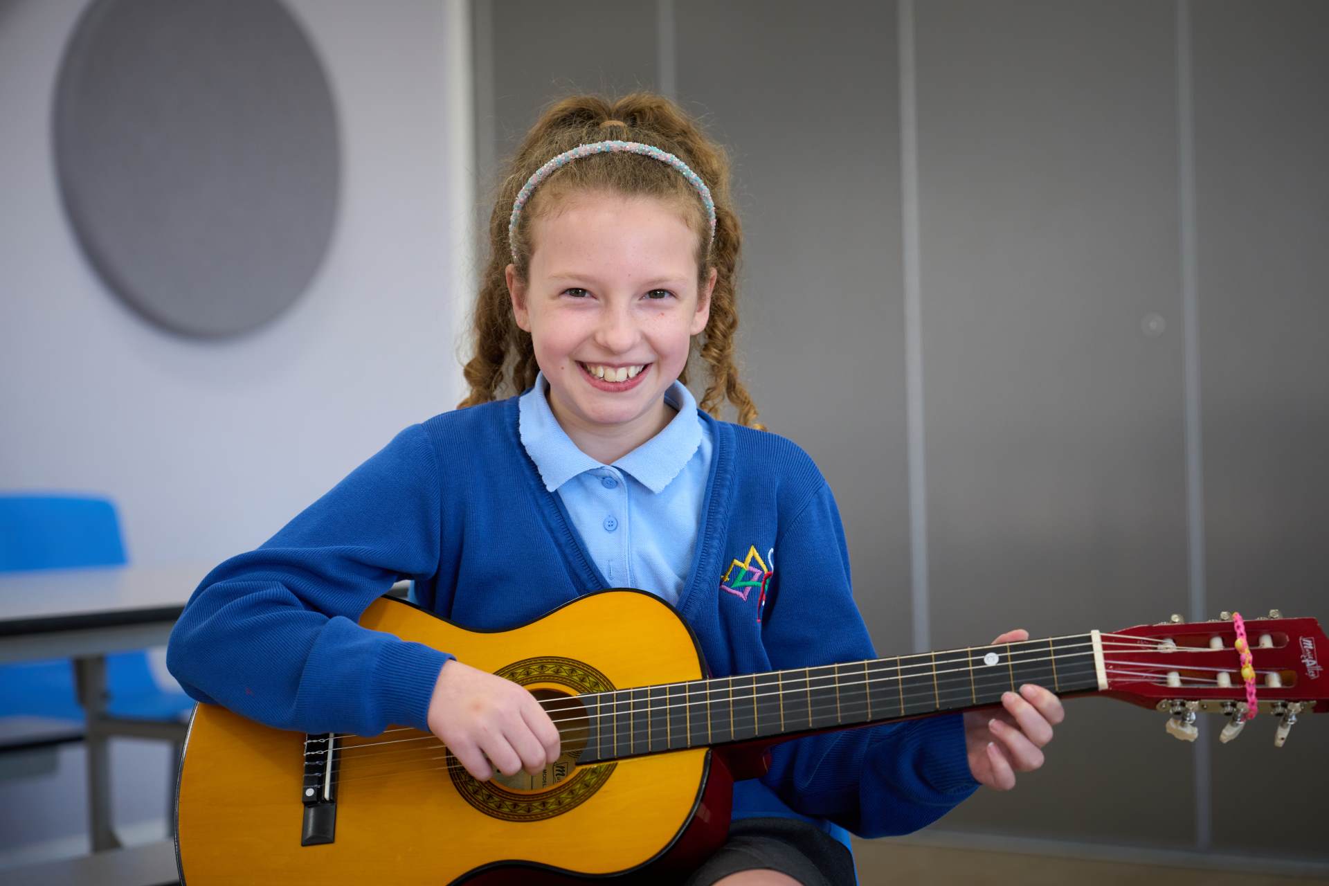 A pupil is playing the guitar Music lesson
